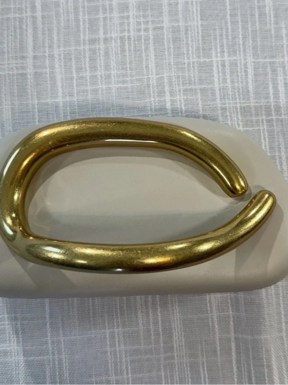 Elegant Cream Clutch with Statement Gold Handle